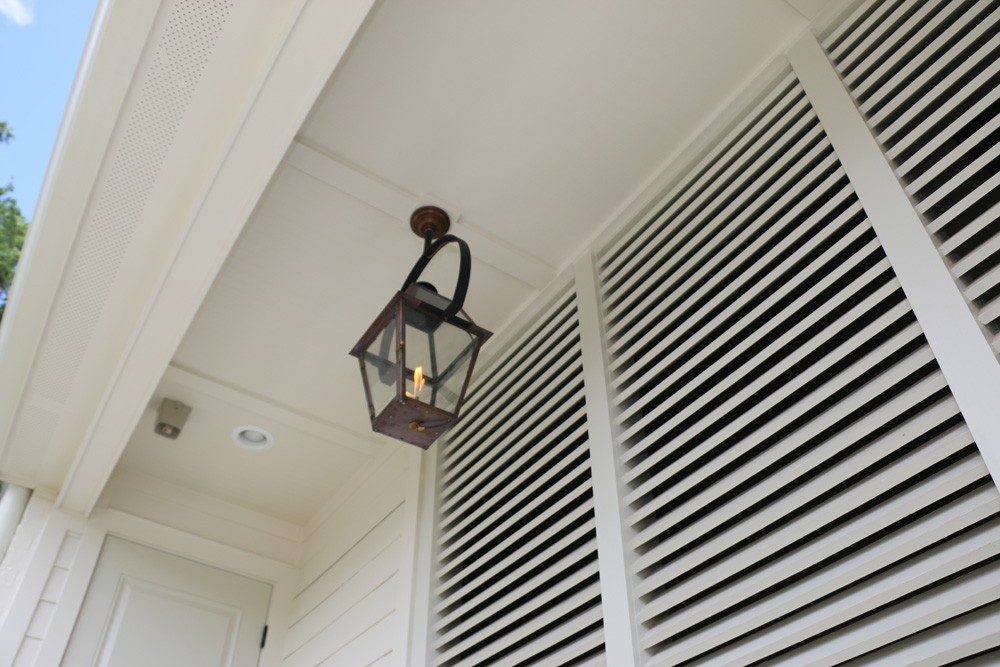 White shutters on porch with gas lantern - Strong Shield