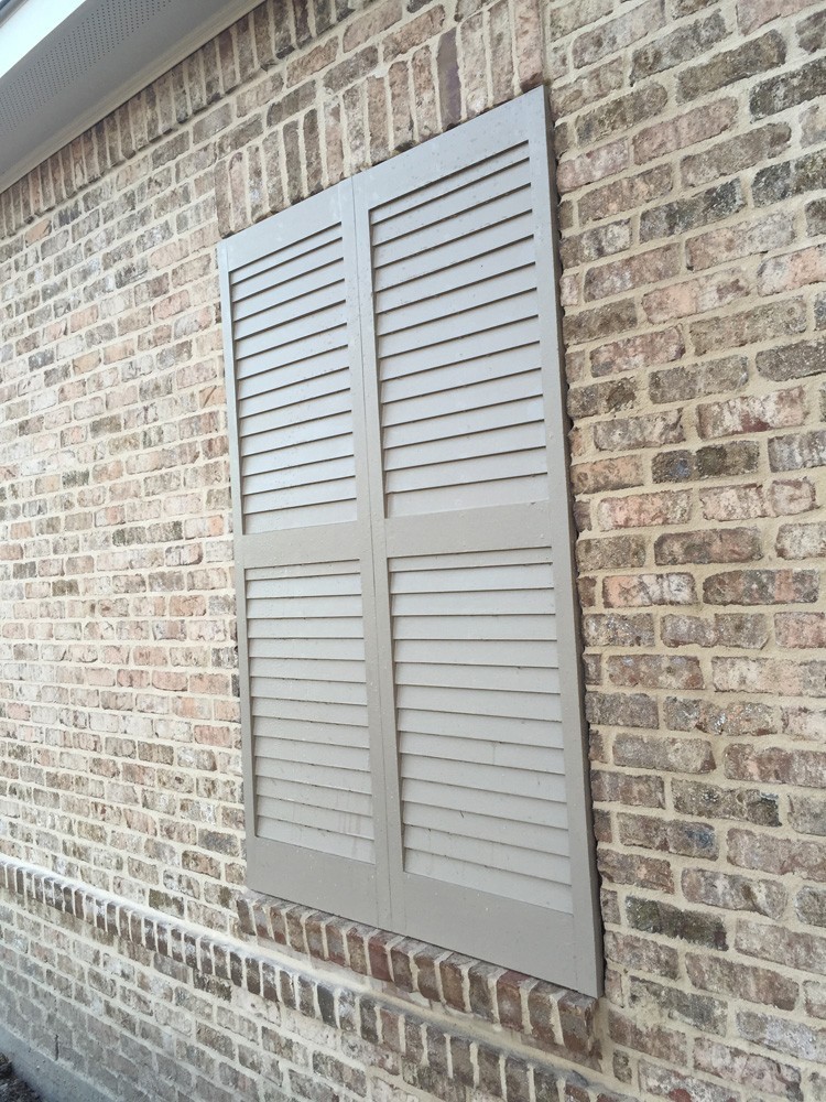 Tan shutters on brown brick with ivory buff mortar - Strong Shield