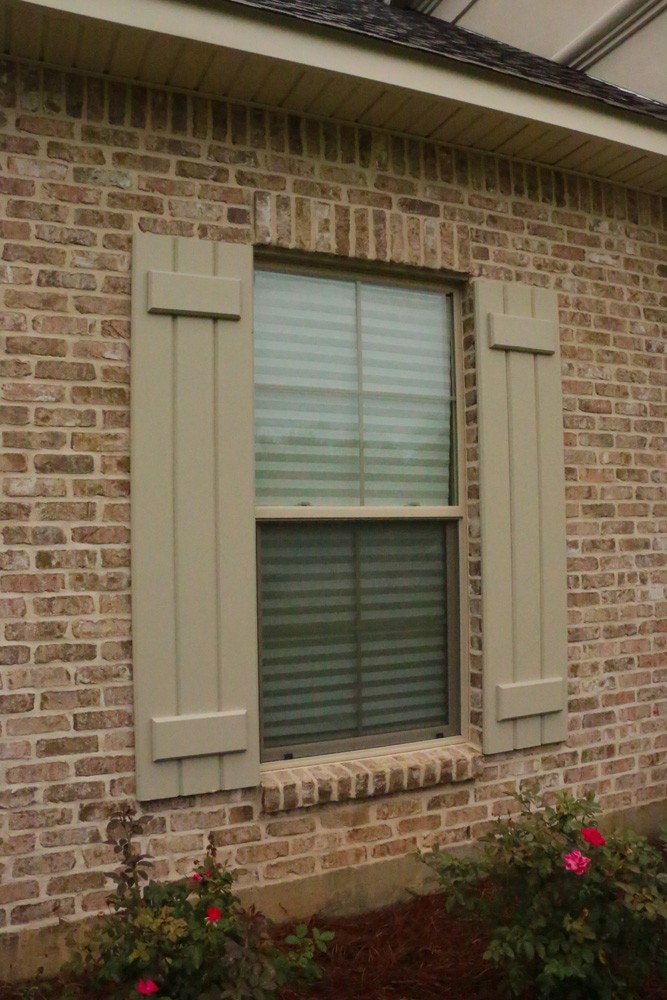 Board and batten shutters on Metairie home - Strong Shield