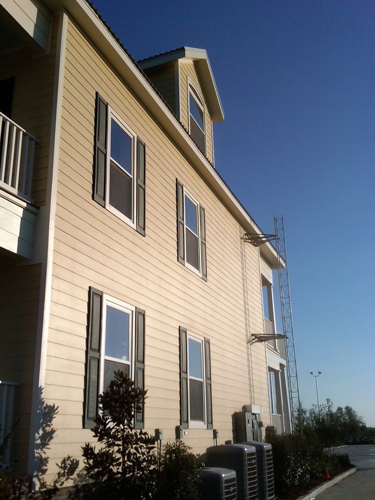 Raised panel shutters on two story hardie home - Strong Shield